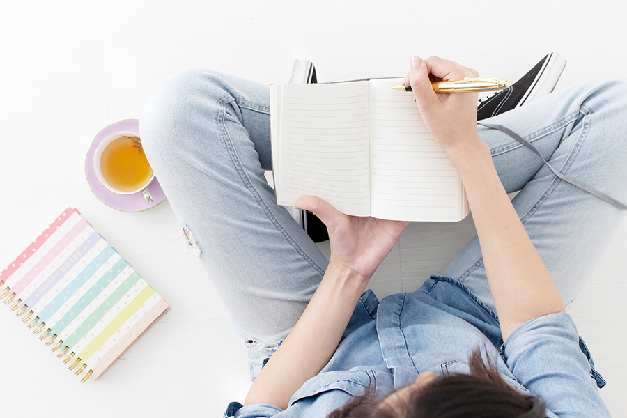 female with notebook learning how to create buyer persona